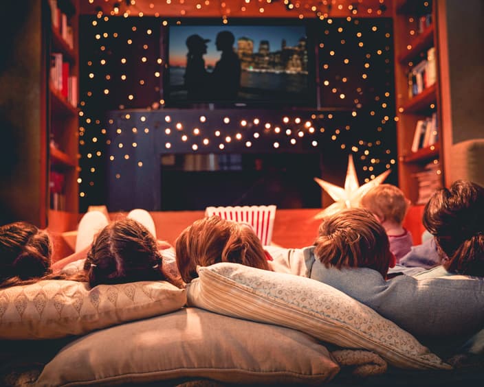 Family enjoying movie night at home together PCM5 V3 R